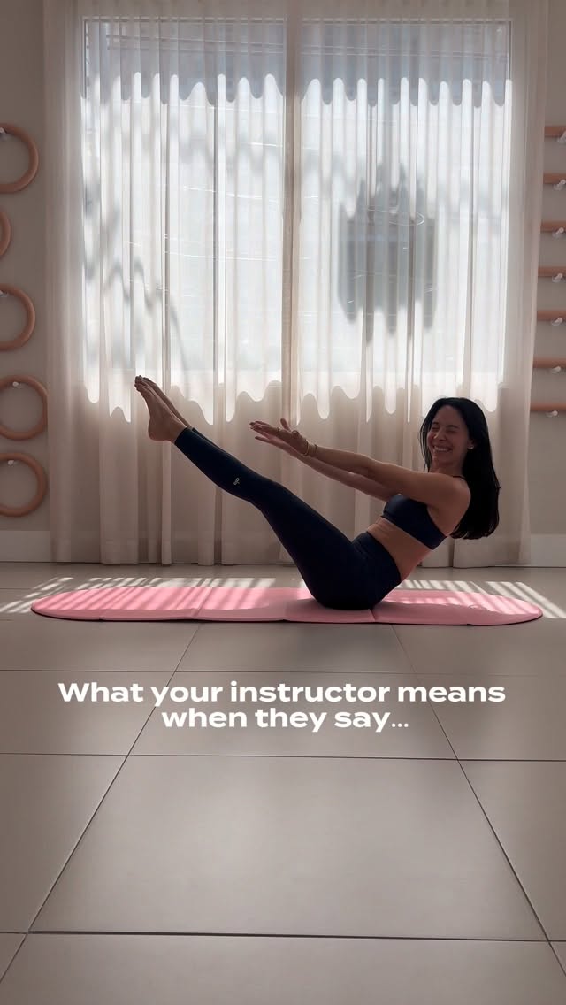 A Studio 22 instructor demonstrating a mat Pilates position